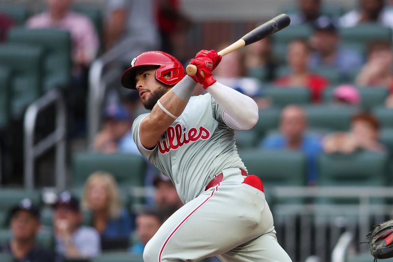 Jul 5, 2024; Atlanta, Georgia, USA; Philadelphia Phillies catcher Rafael Marchan (13) hits a single against the Atlanta Braves in the second inning at Truist Park. Mandatory Credit: Brett Davis-USA TODAY Sports