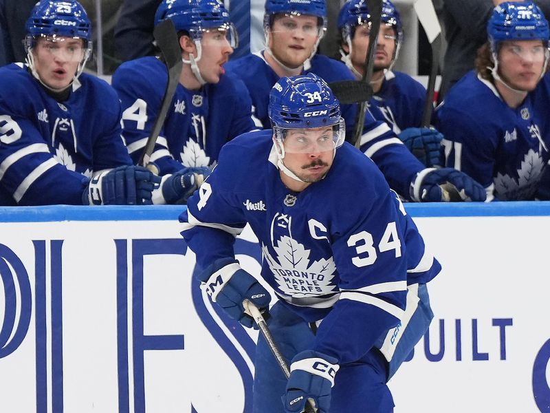 Dec 6, 2024; Toronto, Ontario, CAN; Toronto Maple Leafs center Auston Matthews (34) skates with the puck against the Washington Capitals during  the third period at Scotiabank Arena. Mandatory Credit: Nick Turchiaro-Imagn Images