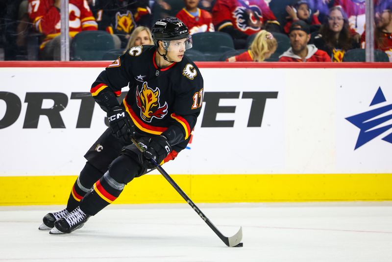 Oct 26, 2024; Calgary, Alberta, CAN; Calgary Flames center Yegor Sharangovich (17) skates with the puck against the Winnipeg Jets during the first period at Scotiabank Saddledome. Mandatory Credit: Sergei Belski-Imagn Images