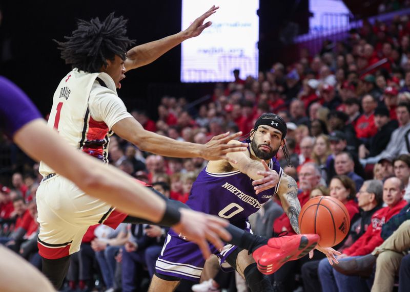 Feb 15, 2024; Piscataway, New Jersey, USA; Rutgers Scarlet Knights guard Jamichael Davis (1) kicks the ball on a pass from Northwestern Wildcats guard Boo Buie (0) during the first half at Jersey Mike's Arena. Mandatory Credit: Vincent Carchietta-USA TODAY Sports