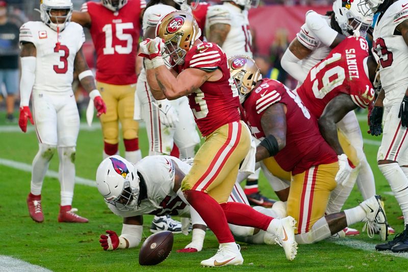 San Francisco 49ers running back Christian McCaffrey, center, celebrates after scoring against the Arizona Cardinals during the second half of an NFL football game Sunday, Dec. 17, 2023, in Glendale, Ariz. (AP Photo/Matt York)