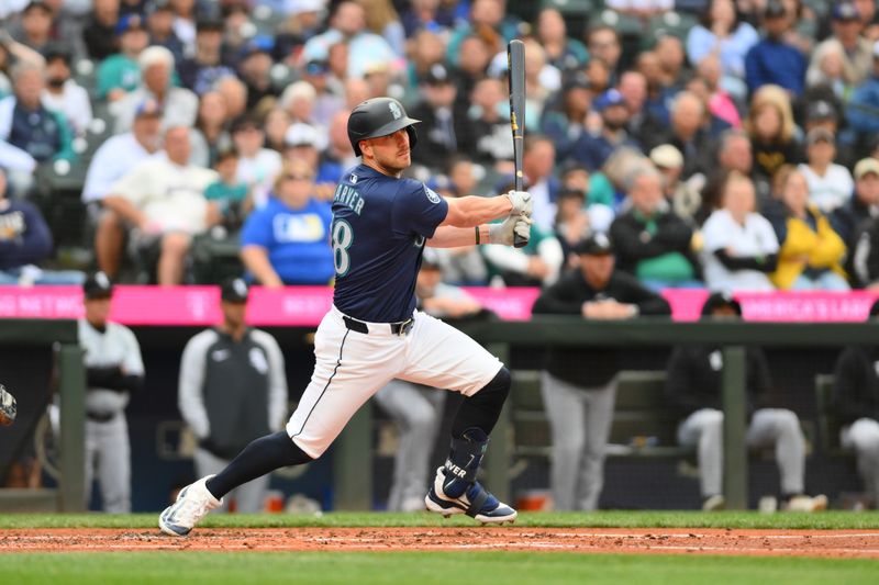 Jun 11, 2024; Seattle, Washington, USA; Seattle Mariners designated hitter Mitch Garver (18) hits an RBI double against the Chicago White Sox during the second inning at T-Mobile Park. Mandatory Credit: Steven Bisig-USA TODAY Sports