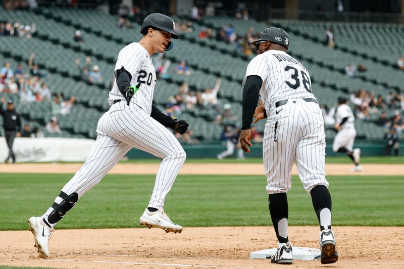 May 1, 2025; Chicago, Illinois, USA; Chicago White Sox third baseman Miguel Vargas (20) celebrates with first base coach coach Jason Bourgeois (38) as he rounds the bases after hitting a three-run home run against the Milwaukee Brewers during the sixth inning at Rate Field. Mandatory Credit: Kamil Krzaczynski-Imagn Images