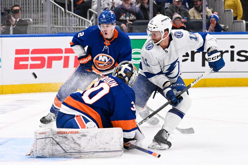 Feb 8, 2024; Elmont, New York, USA; New York Islanders goaltender Ilya Sorokin (30) makes a save on Tampa Bay Lightning center Luke Glendening (11) defended by New York Islanders defenseman Mike Reilly (2)  a during the third period at UBS Arena. Mandatory Credit: Dennis Schneidler-USA TODAY Sports