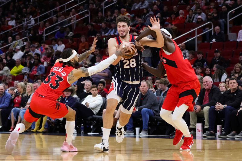 HOUSTON, TEXAS - FEBRUARY 03: Alperen Sengun #28 of the Houston Rockets drives past Gary Trent Jr. #33 of the Toronto Raptors during the first half at Toyota Center on February 03, 2023 in Houston, Texas. NOTE TO USER: User expressly acknowledges and agrees that, by downloading and or using this photograph, User is consenting to the terms and conditions of the Getty Images License Agreement. (Photo by Carmen Mandato/Getty Images)