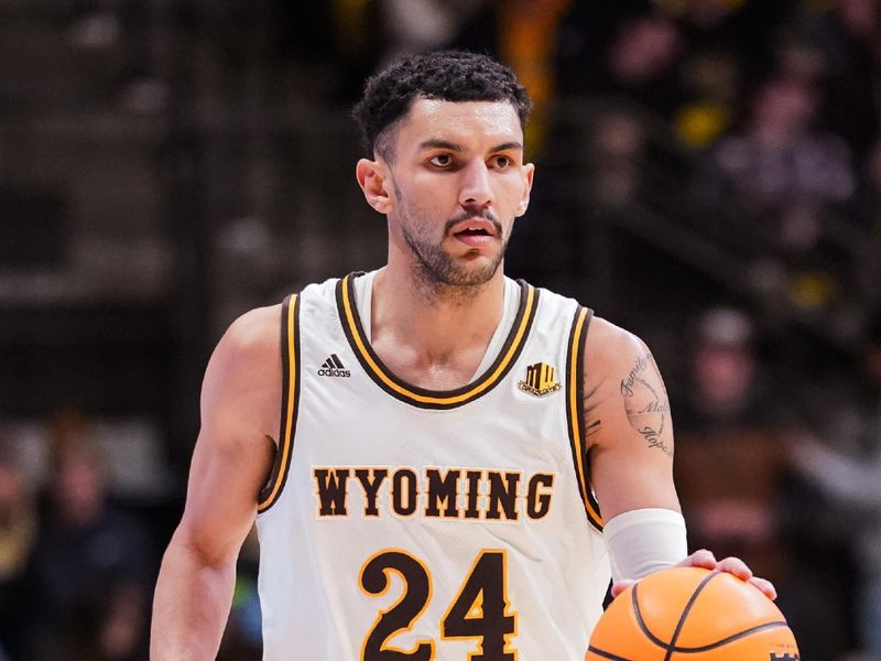 Jan 31, 2023; Laramie, Wyoming, USA; Wyoming Cowboys guard Hunter Maldonado (24) dribbles against the Fresno State Bulldogs during the second half at Arena-Auditorium. Mandatory Credit: Troy Babbitt-USA TODAY Sports