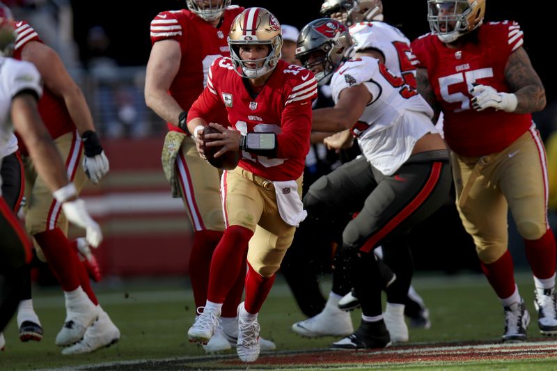 San Francisco 49ers quarterback Brock Purdy (13) runs during an NFL football game against the Tampa Bay Buccaneers, Sunday, Nov. 19, 2023, in Santa Clara, Calif. (AP Photo/Scot Tucker)