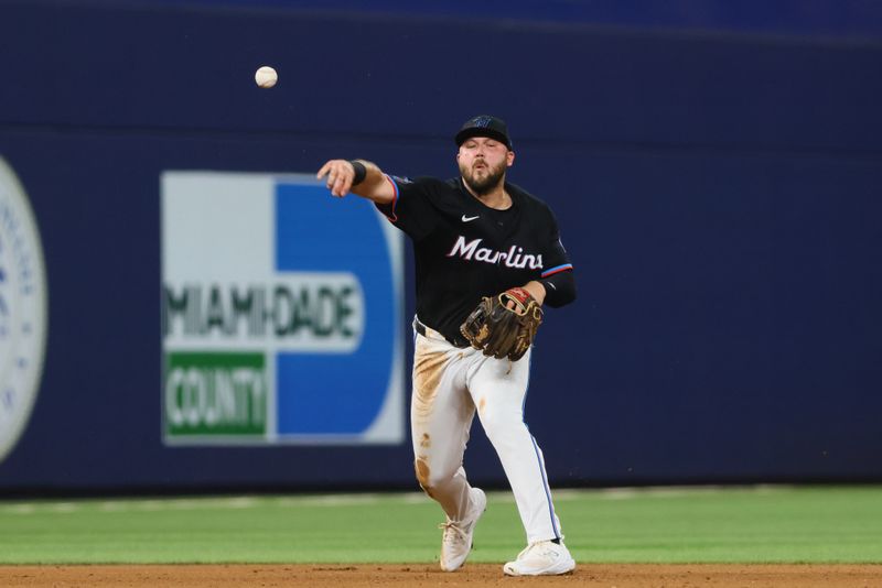 Jul 5, 2024; Miami, Florida, USA; Miami Marlins third baseman Jake Burger (36) throws to first base to retire Chicago White Sox first baseman Andrew Vaughn (not pictured) during the fifth inning at loanDepot Park. Mandatory Credit: Sam Navarro-USA TODAY Sports