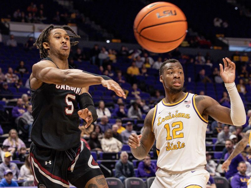 Feb 18, 2023; Baton Rouge, Louisiana, USA; South Carolina Gamecocks guard Meechie Johnson (5) passes there ball around LSU Tigers forward KJ Williams (12) during the second half at Pete Maravich Assembly Center. Mandatory Credit: Stephen Lew-USA TODAY Sports