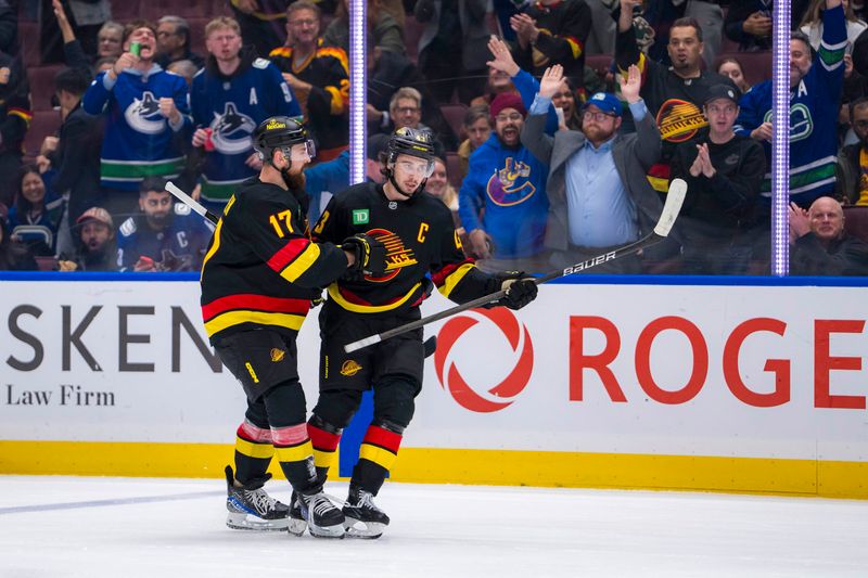 Oct 28, 2024; Vancouver, British Columbia, CAN; Vancouver Canucks defenseman Filip Hronek (17) and defenseman Quinn Hughes (43) celebrate Hughes’ goal against the Carolina Hurricanes during the third period at Rogers Arena. Mandatory Credit: Bob Frid-Imagn Images