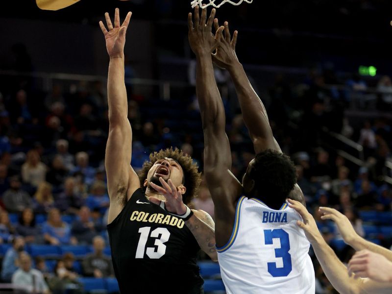 Jan 14, 2023; Los Angeles, California, USA; Colorado Buffaloes guard J'Vonne Hadley (13) shoots the ball over UCLA Bruins forward Adem Bona (3) during the first half at Pauley Pavilion presented by Wescom. Mandatory Credit: Kiyoshi Mio-USA TODAY Sports