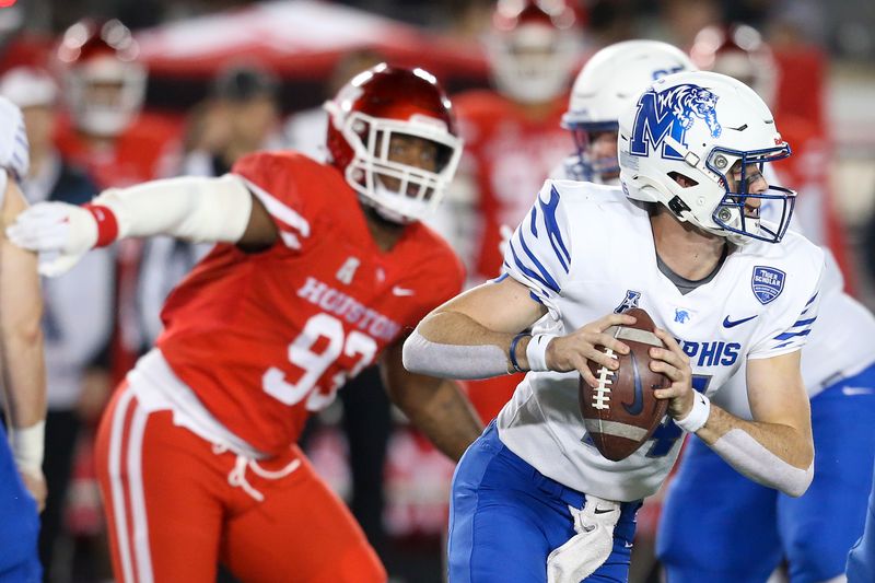 Nov 19, 2021; Houston, Texas, USA;  Memphis Tigers quarterback Seth Henigan (14) rushes against Houston Cougars defensive lineman Atlias Bell (93) in the second quarter at TDECU Stadium. Mandatory Credit: Thomas Shea-USA TODAY Sports