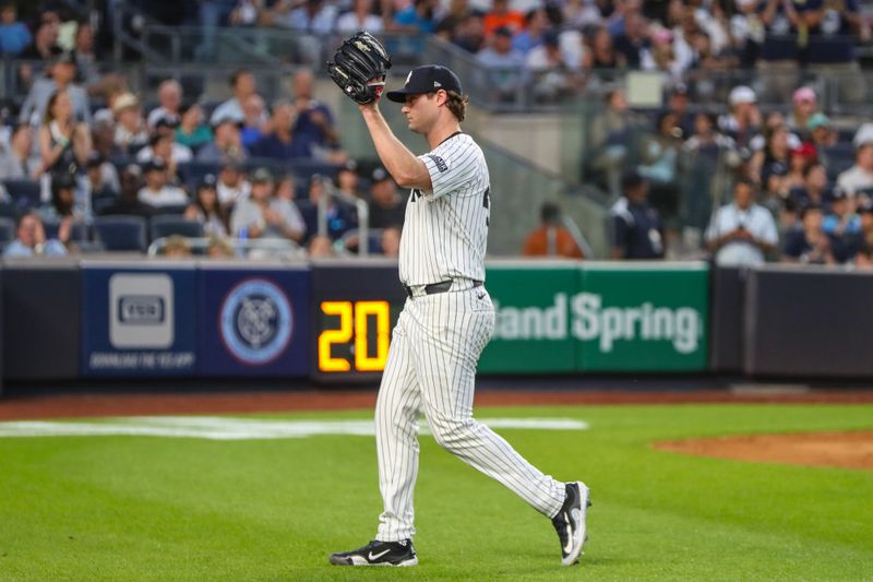 Jun 19, 2024; Bronx, New York, USA;  New York Yankees starting pitcher Gerrit Cole (45) waves to the crowd after he is taken out of the game in the fifth inning against the Baltimore Orioles at Yankee Stadium. Mandatory Credit: Wendell Cruz-USA TODAY Sports