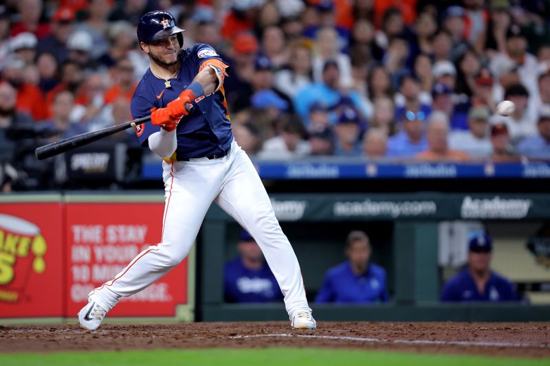 Jul 28, 2024; Houston, Texas, USA; Houston Astros catcher Yainer Diaz (21) hits a two-run home run to left-center against the Los Angeles Dodgers during the sixth inning at Minute Maid Park. Mandatory Credit: Erik Williams-USA TODAY Sports