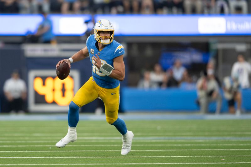 Los Angeles Chargers quarterback Justin Herbert (10) runs with the ball during an NFL football game against the Tennessee Titans, Sunday, Nov. 10, 2024, in Inglewood, Calif. (AP Photo/Kyusung Gong)