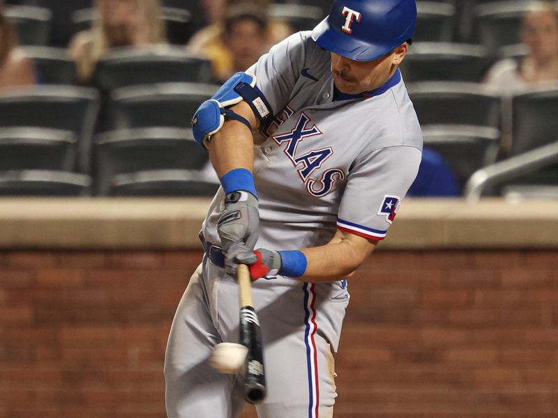 Aug 28, 2023; New York City, New York, USA;  Texas Rangers first baseman Nathaniel Lowe (30) singles during the ninth inning against the New York Mets at Citi Field. Mandatory Credit: Vincent Carchietta-USA TODAY Sports