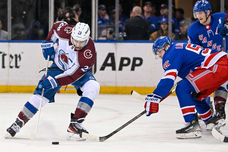 Feb 5, 2024; New York, New York, USA;  Colorado Avalanche left wing Miles Wood (28) attempts a back hand shot defended by New York Rangers defenseman Ryan Lindgren (55) during the second period at Madison Square Garden. Mandatory Credit: Dennis Schneidler-USA TODAY Sports