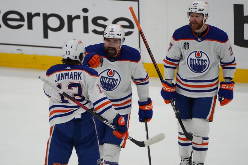 Jun 24, 2024; Sunrise, Florida, USA; Edmonton Oilers forward Mattias Janmark (13) celebrates with defenseman Aaron Ekblad (5) and forward Eetu Luostarinen (27) after scoring against Florida Panthers goaltender Sergei Bobrovsky (72) during the first period in game seven of the 2024 Stanley Cup Final at Amerant Bank Arena. Mandatory Credit: Jim Rassol-USA TODAY Sports