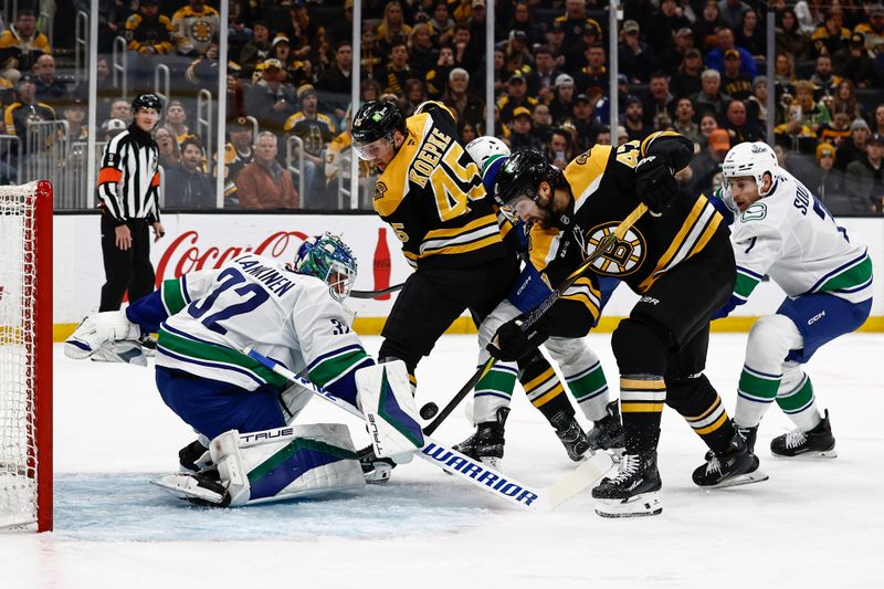 Nov 26, 2024; Boston, Massachusetts, USA; Boston Bruins center Mark Kastelic (47) goes for a rebound in front of Vancouver Canucks goaltender Kevin Lankinen (32) during the first period at TD Garden. Mandatory Credit: Winslow Townson-Imagn Images