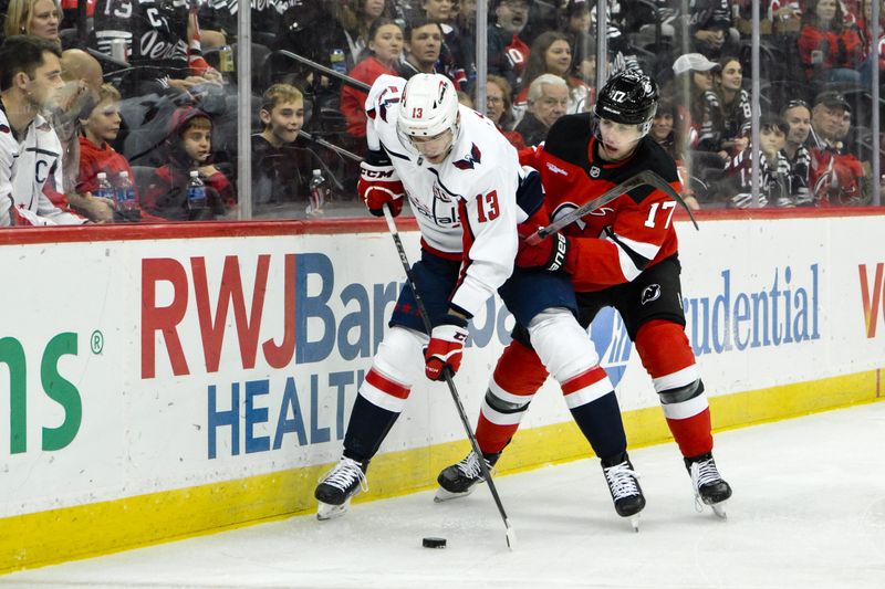 Oct 19, 2024; Newark, New Jersey, USA; Washington Capitals left wing Jakub Vrana (13) skates with the puck against New Jersey Devils defenseman Simon Nemec (17) during the first period at Prudential Center. Mandatory Credit: John Jones-Imagn Images