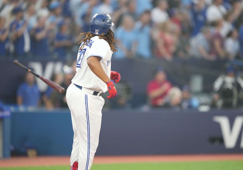 Jun 29, 2023; Toronto, Ontario, CAN; Toronto Blue Jays designated hitter Vladimir Guerrero Jr. (27) throws his bat after hitting a two run home run against the San Francisco Giants during the sixth inning at Rogers Centre. Mandatory Credit: Nick Turchiaro-USA TODAY Sports