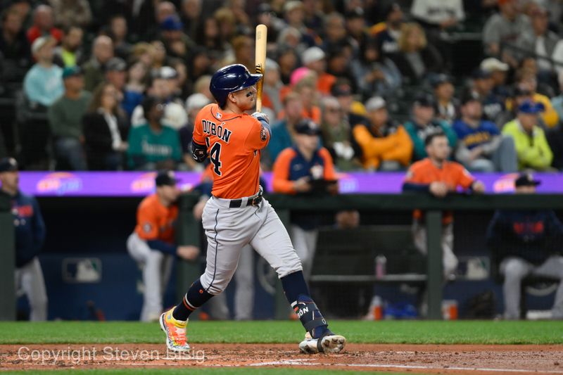 Sep 27, 2023; Seattle, Washington, USA; Houston Astros center fielder Mauricio Dubon (14) hits a 3-run home run against the Seattle Mariners during the fourth inning at T-Mobile Park. Mandatory Credit: Steven Bisig-USA TODAY Sports