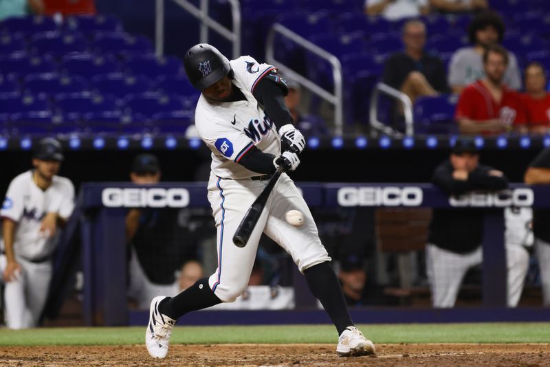 Sep 4, 2024; Miami, Florida, USA; Miami Marlins shortstop Xavier Edwards (63) hits a single agains the Washington Nationals during the eighth inning at loanDepot Park. Mandatory Credit: Sam Navarro-Imagn Images