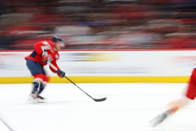 Feb 25, 2025; Washington, District of Columbia, USA; Washington Capitals defenseman Rasmus Sandin (38) skates with the puck against the Calgary Flames in the second period at Capital One Arena. Mandatory Credit: Geoff Burke-Imagn Images