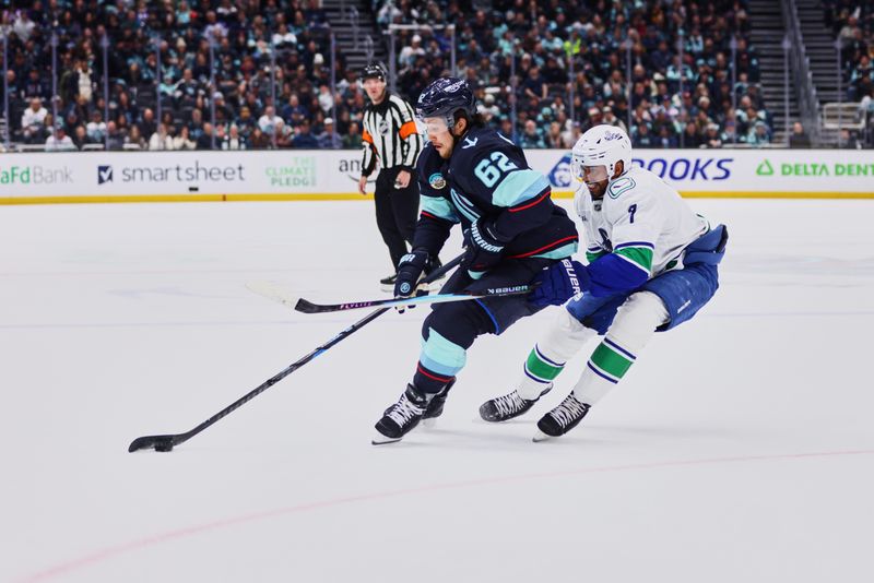 Feb 28, 2026; Seattle, Washington, USA;  Seattle Kraken defenseman Brandon Montour (62) turns on the puck as Vancouver Canucks defenseman Pierre-Olivier Joseph (7) defends during the second period at Climate Pledge Arena. Mandatory Credit: Blake Dahlin-Imagn Images