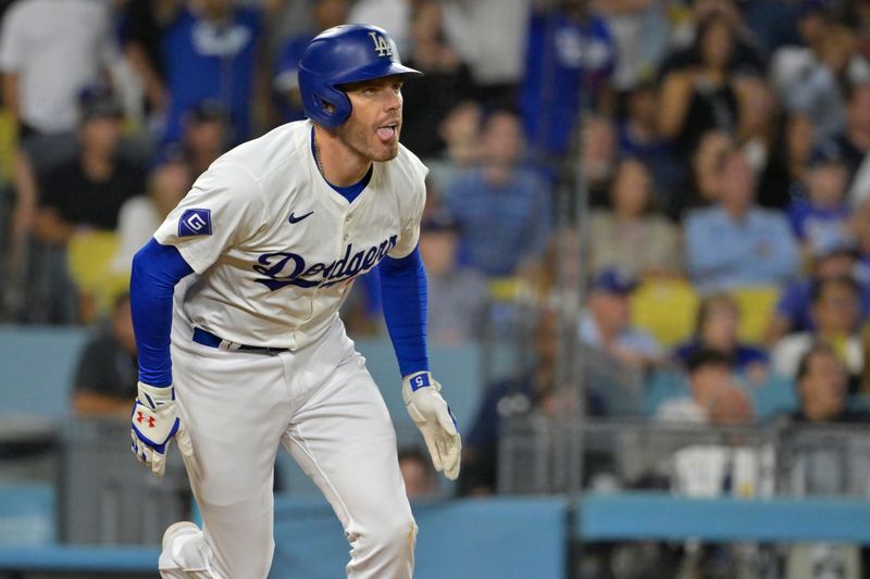 Jul 19, 2024; Los Angeles, California, USA;  Los Angeles Dodgers first base Freddie Freeman (5) watches the flight of the ball on a grand slam home run in the eighth inning against the Boston Red Sox at Dodger Stadium. Mandatory Credit: Jayne Kamin-Oncea-USA TODAY Sports