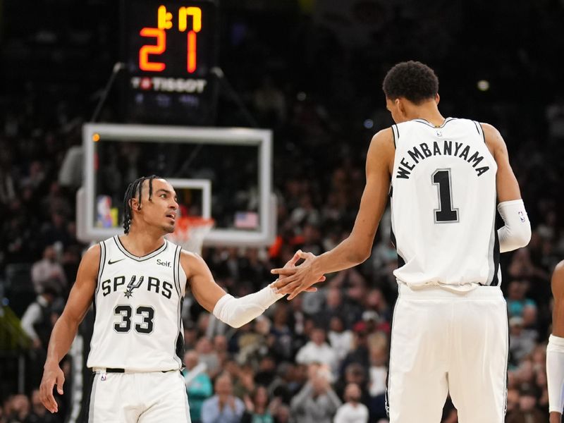 SAN ANTONIO, TX - FEBRUARY 29: Tre Jones #33 high fives Victor Wembanyama #1 of the San Antonio Spurs during the game against the Oklahoma City Thunder on February 29, 2024 at the Frost Bank Center in San Antonio, Texas. NOTE TO USER: User expressly acknowledges and agrees that, by downloading and or using this photograph, user is consenting to the terms and conditions of the Getty Images License Agreement. Mandatory Copyright Notice: Copyright 2024 NBAE (Photos by Darren Carroll/NBAE via Getty Images)