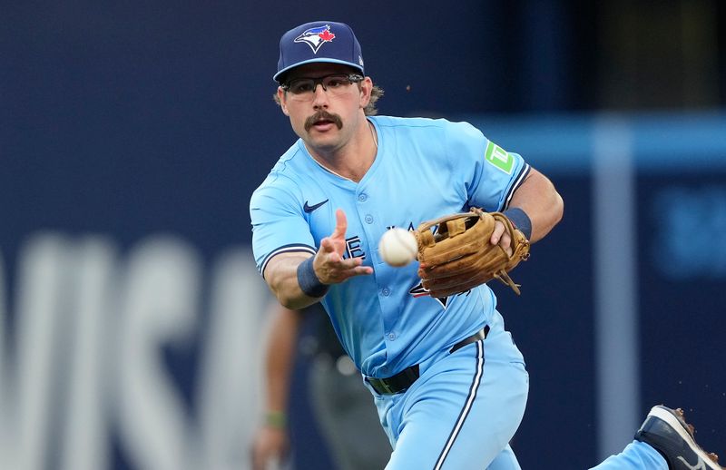 May 22, 2024; Toronto, Ontario, CAN; Toronto Blue Jays second baseman Davis Schneider (36) throws to first base to get out Chicago White Sox left fielder Andrew Benintendi (not pictured) during the third inning at Rogers Centre. Mandatory Credit: John E. Sokolowski-USA TODAY Sports