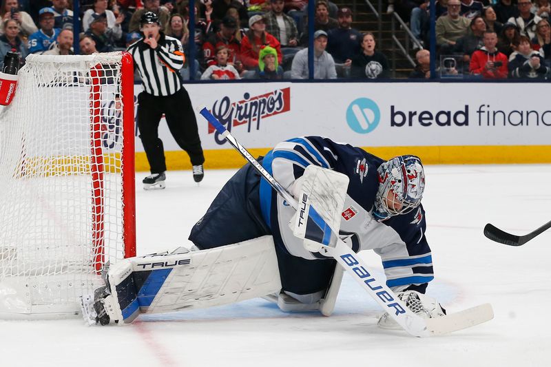 Nov 1, 2024; Columbus, Ohio, USA; Winnipeg Jets goalie Eric Comrie (1) makes a save against the Columbus Blue Jackets during the second period at Nationwide Arena. Mandatory Credit: Russell LaBounty-Imagn Images