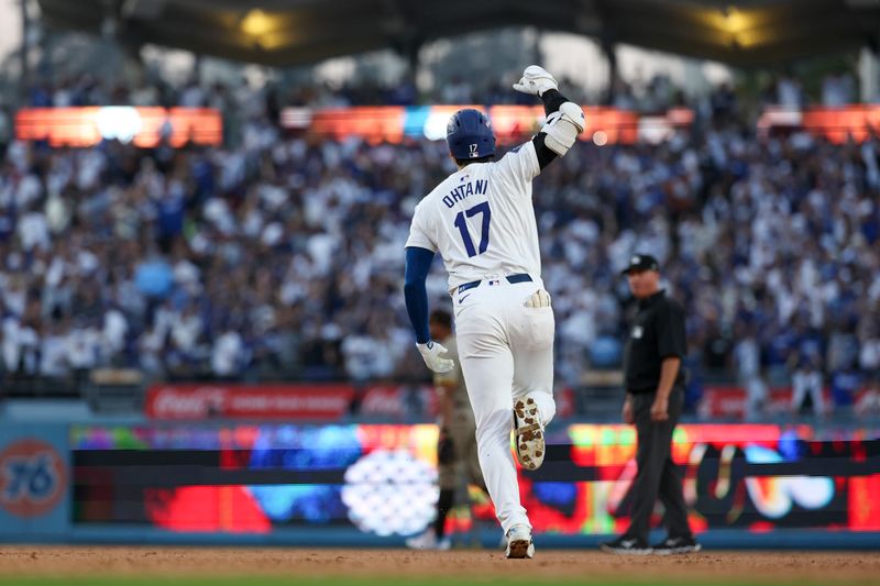 Oct 5, 2024; Los Angeles, California, USA; Los Angeles Dodgers designated hitter Shohei Ohtani (17) scores a home run against the San Diego Padres during game one of the NLDS for the 2024 MLB Playoffs at Dodger Stadium. Mandatory Credit: Kiyoshi Mio-Imagn Images