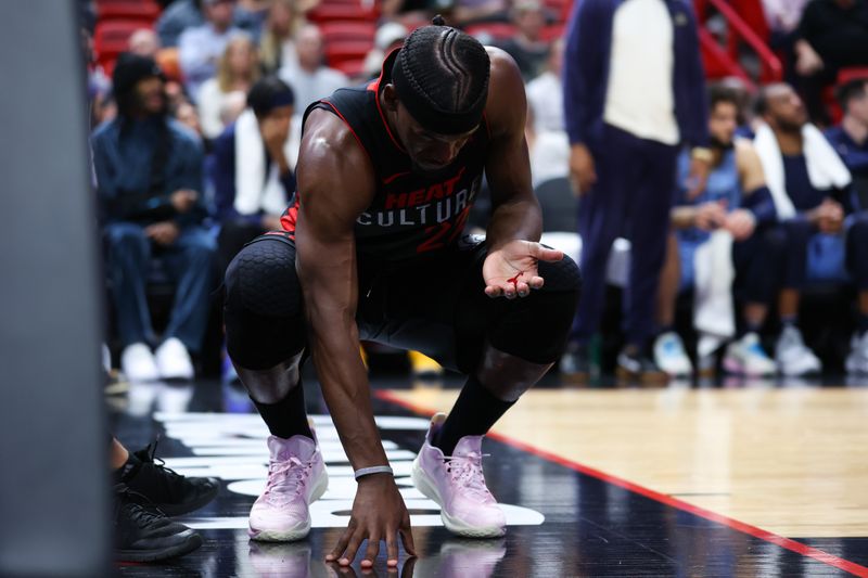 MIAMI, FLORIDA - JANUARY 24: Jimmy Butler #22 of the Miami Heat looks at blood on his hand during the fourth quarter of the game against the Memphis Grizzlies at Kaseya Center on January 24, 2024 in Miami, Florida. NOTE TO USER: User expressly acknowledges and agrees that, by downloading and or using this photograph, User is consenting to the terms and conditions of the Getty Images License Agreement. (Photo by Megan Briggs/Getty Images)