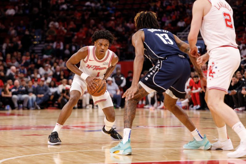 HOUSTON, TEXAS - DECEMBER 22: Amen Thompson #1 of the Houston Rockets controls the ball in the second half while defended by Greg Brown III #13 of the Dallas Mavericks at Toyota Center on December 22, 2023 in Houston, Texas.   NOTE TO USER: User expressly acknowledges and agrees that, by downloading and or using this photograph, User is consenting to the terms and conditions of the Getty Images License Agreement. (Photo by Tim Warner/Getty Images)