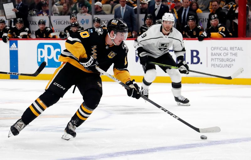 Feb 18, 2024; Pittsburgh, Pennsylvania, USA;  Pittsburgh Penguins left wing Drew O'Connor (10) skates with the puck against the Los Angeles Kings during the third period at PPG Paints Arena. Los Angeles won 2-1. Mandatory Credit: Charles LeClaire-USA TODAY Sports