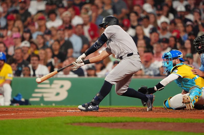 Jul 27, 2024; Boston, Massachusetts, USA; New York Yankees shortstop Anthony Volpe (11) hits a single against the Boston Red Sox during the seventh inning at Fenway Park. Mandatory Credit: Gregory Fisher-USA TODAY Sports