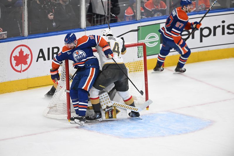 May 12, 2025; Edmonton, Alberta, CAN; Edmonton Oilers left winger Zach Hyman (18) colides with Vegas Golden Knights goalie Adin Hill (33) and defenseman Nicolas Hague (14) during the second period in game three of the second round of the 2025 Stanley Cup Playoffs at Rogers Place. Mandatory Credit: Walter Tychnowicz-Imagn Images