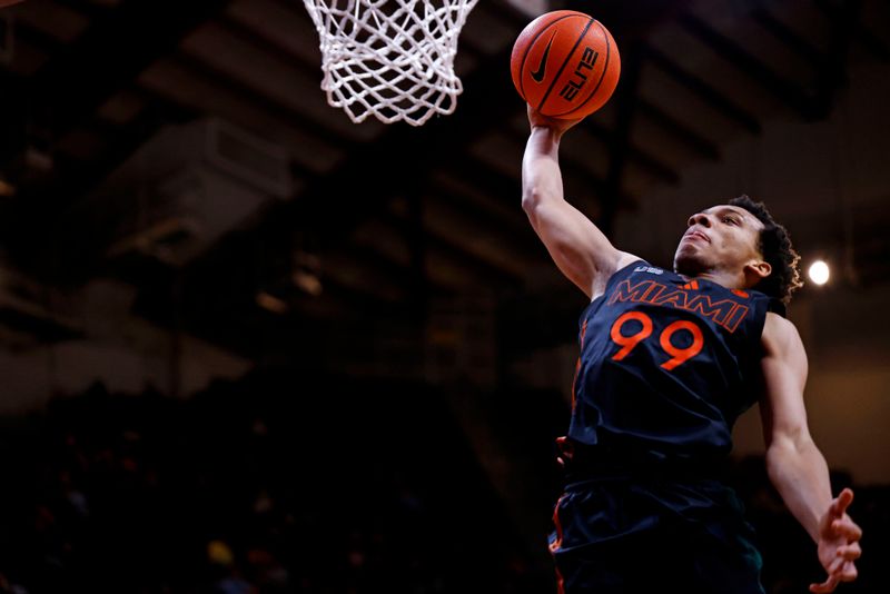 Jan 4, 2025; Blacksburg, Virginia, USA; Miami Hurricanes guard Divine Ugochukwu (99) dunks the ball during the second half against the Virginia Tech Hokies at Cassell Coliseum. Mandatory Credit: Peter Casey-Imagn Images