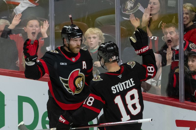 Nov 23, 2024; Ottawa, Ontario, CAN; Ottawa Senators center Tim Stutzle (18) celebrates with right wing Claude Giroux (28) his goal scored in the third period against the Vancouver Canucks at the Canadian Tire Centre. Mandatory Credit: Marc DesRosiers-Imagn Images