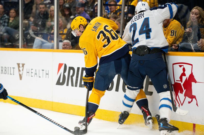 Nov 23, 2024; Nashville, Tennessee, USA;  Nashville Predators left wing Cole Smith (36) and Winnipeg Jets defenseman Haydn Fleury (24) fight for the puck during the first period at Bridgestone Arena. Mandatory Credit: Steve Roberts-Imagn Images