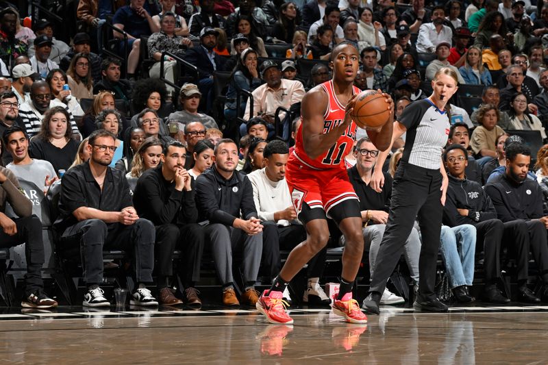 BROOKLYN, NY - NOVEMBER 9: Ayo Dosunmu #11 of the Chicago Bulls shoots a three point basket during the game  against the Brooklyn Nets on November 9, 2024 at Barclays Center in Brooklyn, New York. NOTE TO USER: User expressly acknowledges and agrees that, by downloading and or using this Photograph, user is consenting to the terms and conditions of the Getty Images License Agreement. Mandatory Copyright Notice: Copyright 2024 NBAE (Photo by David Dow/NBAE via Getty Images)