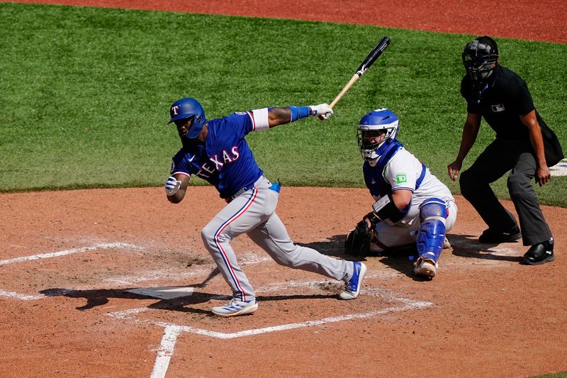 Jul 28, 2024; Toronto, Ontario, CAN; Texas Rangers designated hitter Adolis García (53) hits a single against the Toronto Blue Jays during the eighth inning at Rogers Centre. Mandatory Credit: John E. Sokolowski-USA TODAY Sports