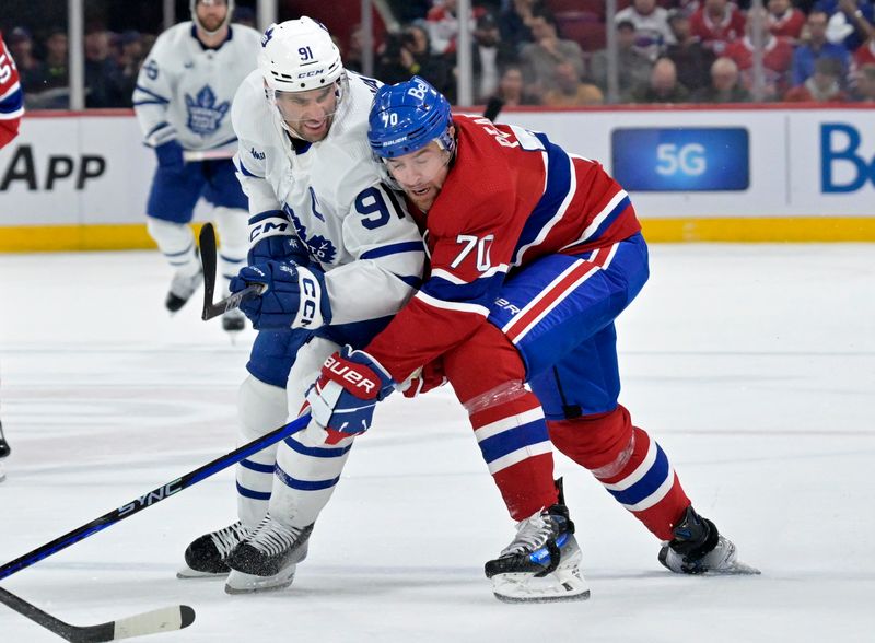 Mar 9, 2024; Montreal, Quebec, CAN; Toronto Maple Leafs forward John Tavares (91) and Montreal Canadiens forward Tanner Pearson (70) battle during the third period at the Bell Centre. Mandatory Credit: Eric Bolte-USA TODAY Sports