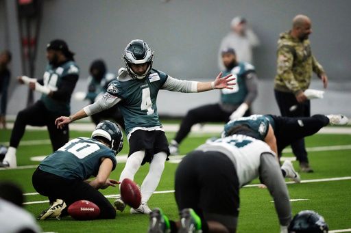 Philadelphia Eagles place kicker Jake Elliott (4) kicks a ball as his teammates warms up during NFL football practice in Philadelphia, Friday, Jan. 31, 2025, ahead of Super Bowl 59 against the Kansas City Chiefs. (AP Photo/Matt Rourke)