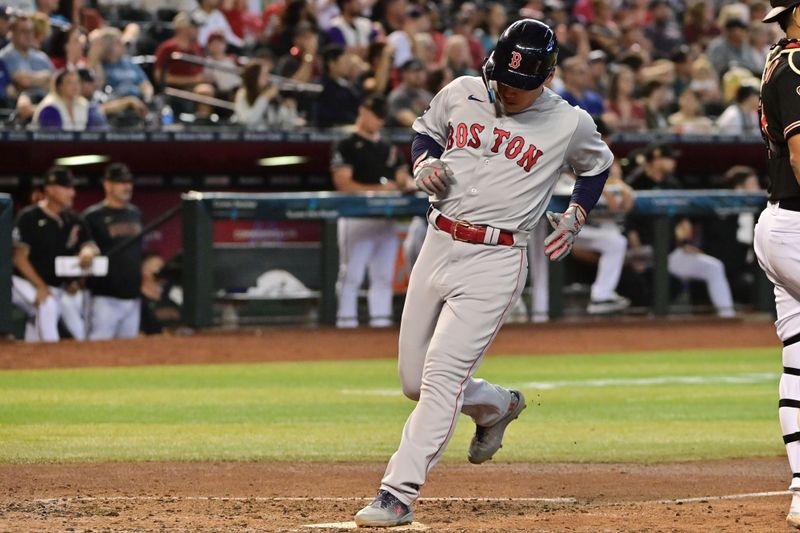 May 27, 2023; Phoenix, Arizona, USA;  Boston Red Sox left fielder Masataka Yoshida (7) scores against the Arizona Diamondbacks in the fourth inning at Chase Field. Mandatory Credit: Matt Kartozian-USA TODAY Sports