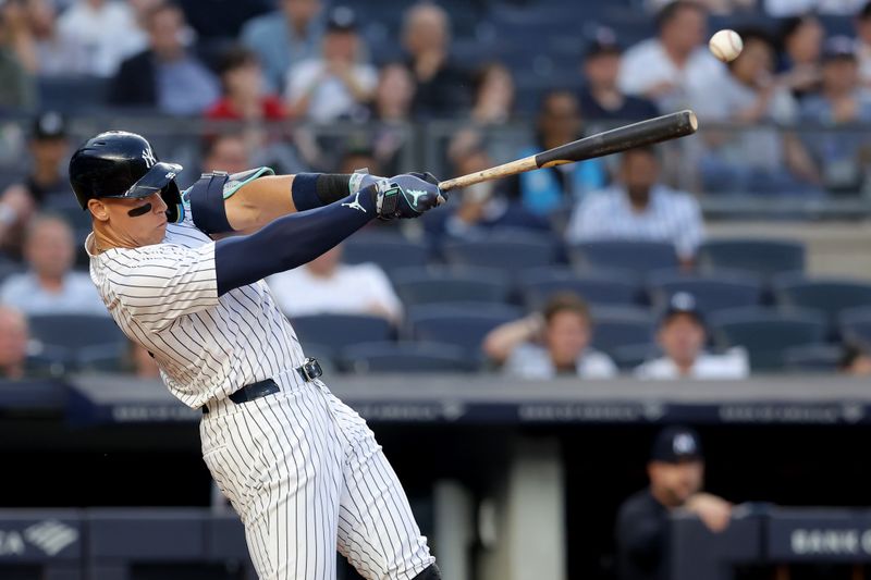 Jun 4, 2024; Bronx, New York, USA; New York Yankees center fielder Aaron Judge (99) hits a two run double against the Minnesota Twins during the third inning at Yankee Stadium. Mandatory Credit: Brad Penner-USA TODAY Sports