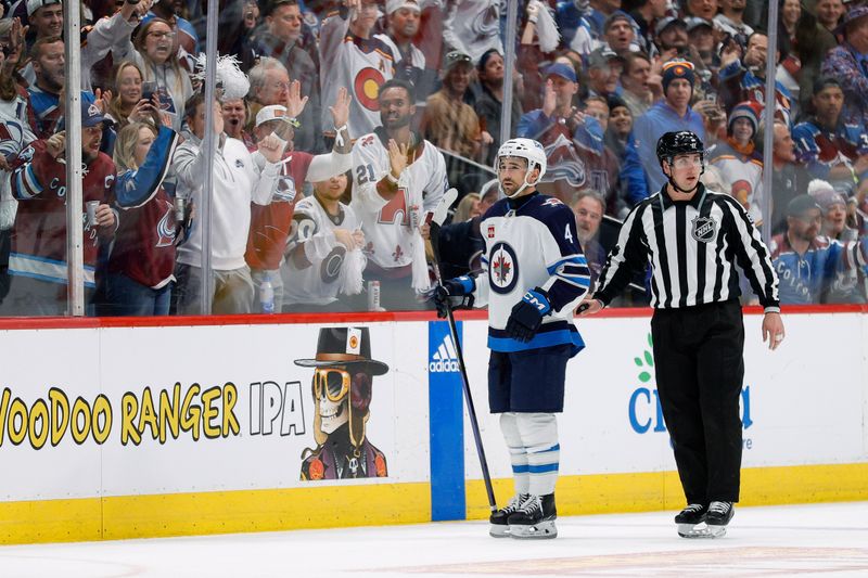 Apr 26, 2024; Denver, Colorado, USA; Colorado Avalanche fans react as Winnipeg Jets defenseman Neal Pionk (4) is skated to the penalty box by linesman James Tobias (61) in the third period in game three of the first round of the 2024 Stanley Cup Playoffs at Ball Arena. Mandatory Credit: Isaiah J. Downing-USA TODAY Sports