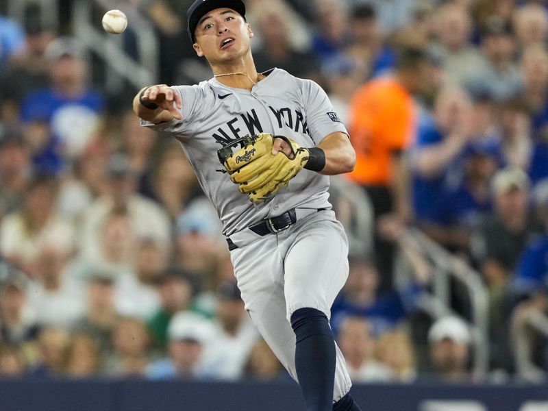 Jun 29, 2024; Toronto, Ontario, CAN; New York Yankees shortstop Anthony Volpe (11) throws to first base against the Toronto Blue Jays during the first inning at Rogers Centre. Mandatory Credit: Kevin Sousa-USA TODAY Sports